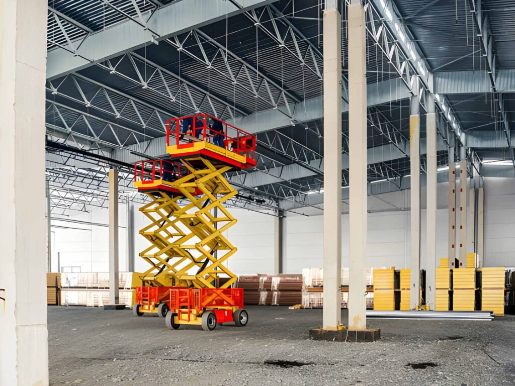 Facility management technician using scissor lift rental for maintenance work in Dubai